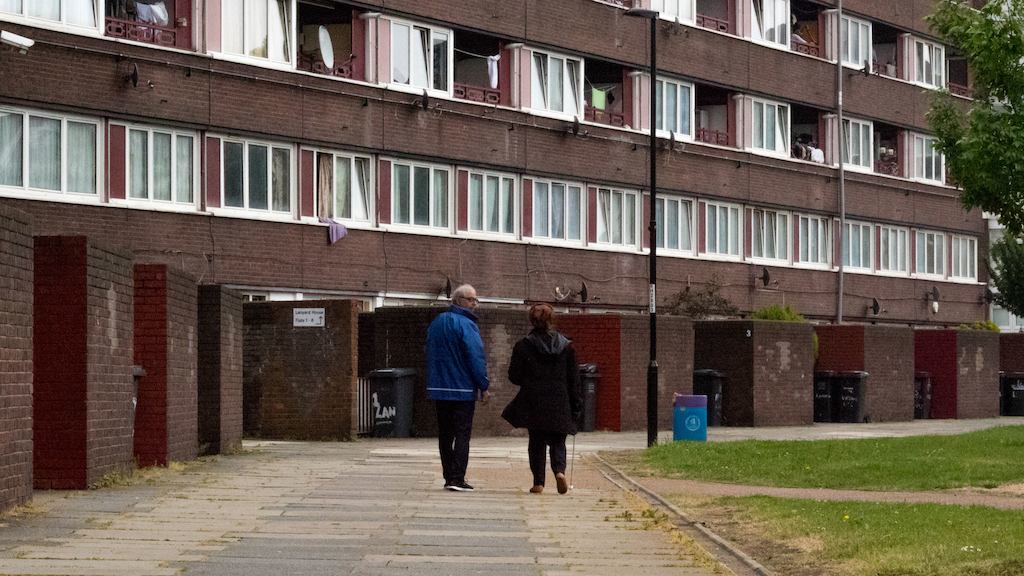 Man and woman walking on an estate.