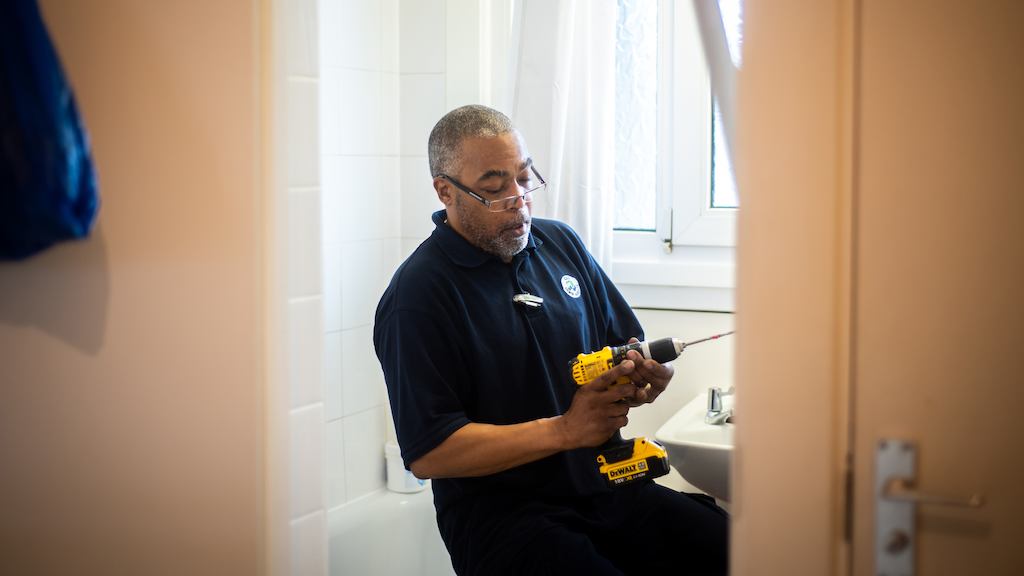 Handyman installing housing adaptation