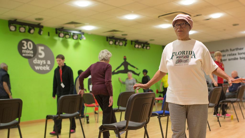 Elderly people participating in a strength and balance class.