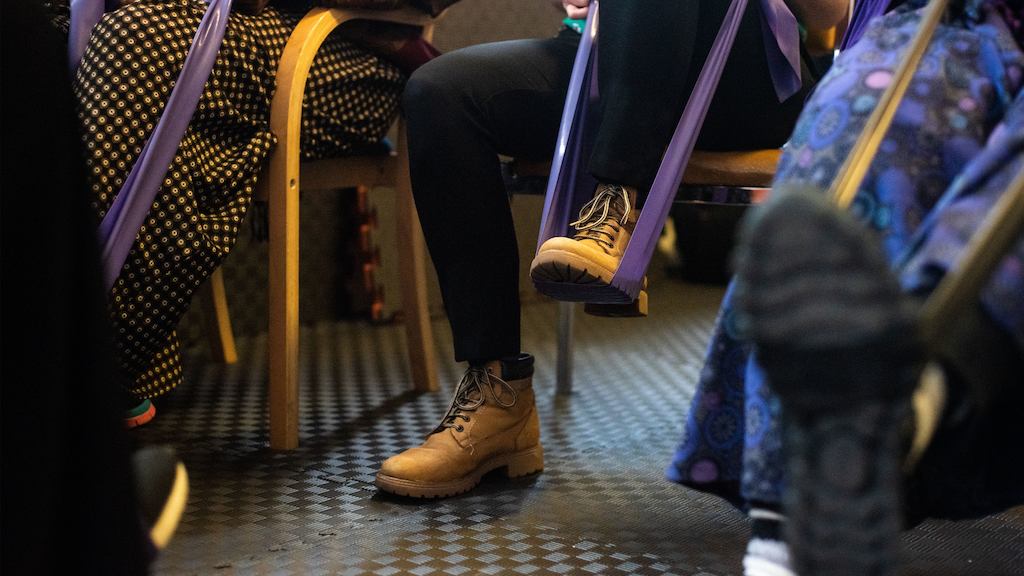 A person using a resistance band with their foot