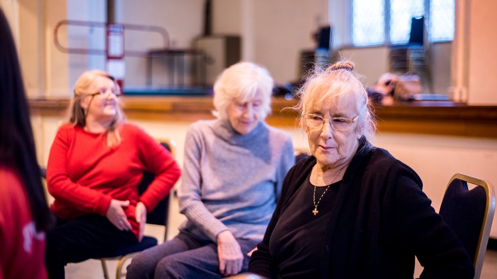 Valerie, an older woman, sitting on a chair