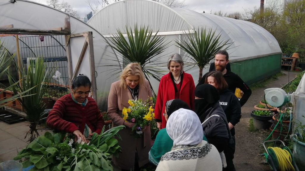 Anna Dixon, Mims Davis and a Sustain volunteer around a garden allotment