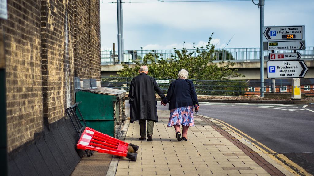 Older couple walking in street