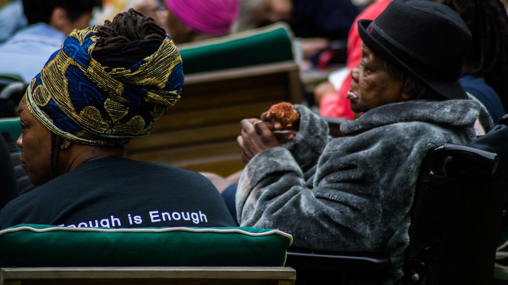 Two women sitting on chairs outside