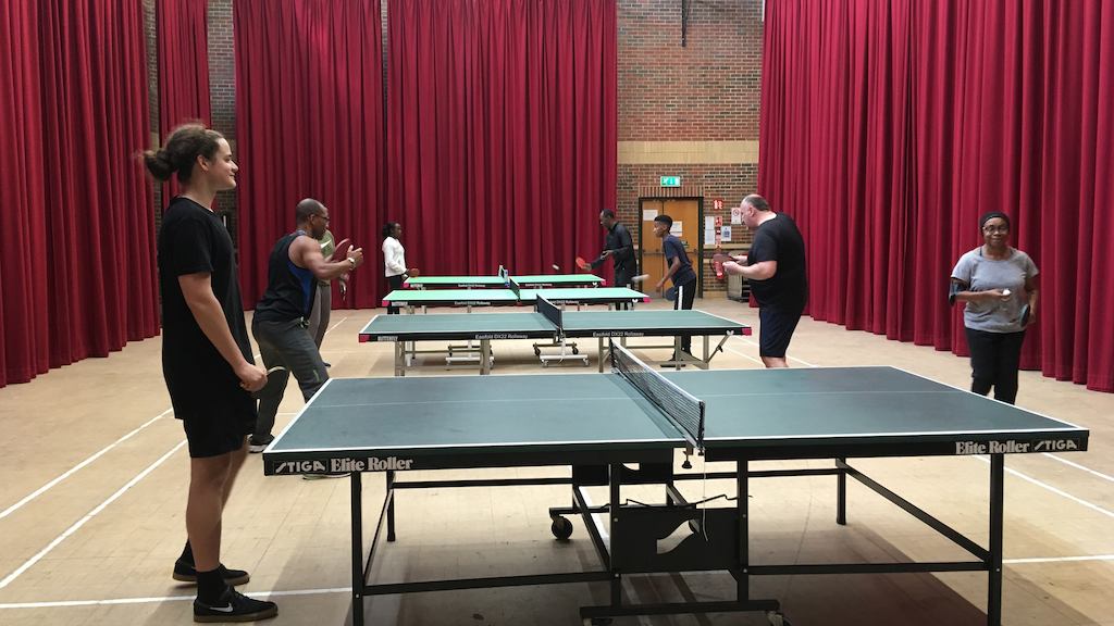 Group playing table tennis