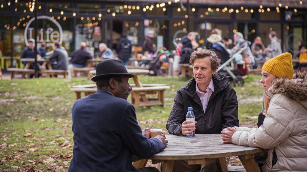 Group of people talking by a table