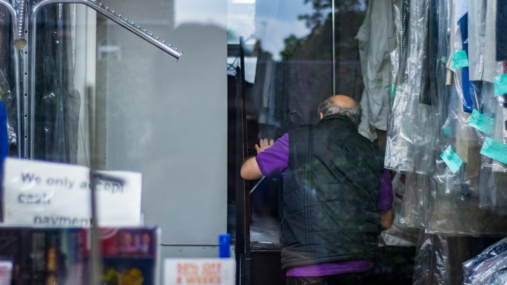 Older man in dry cleaner