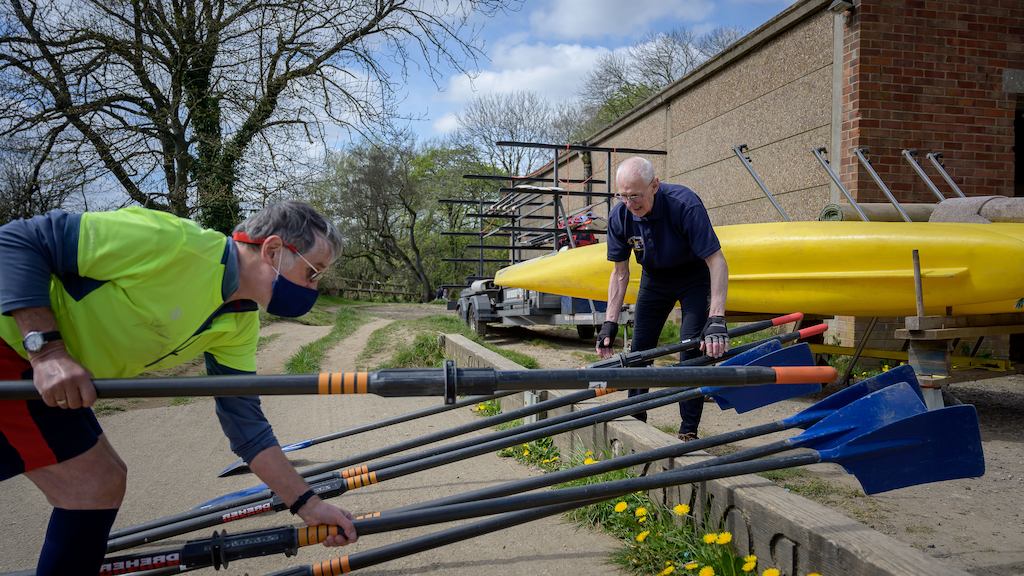 Older man preparing rowing boat