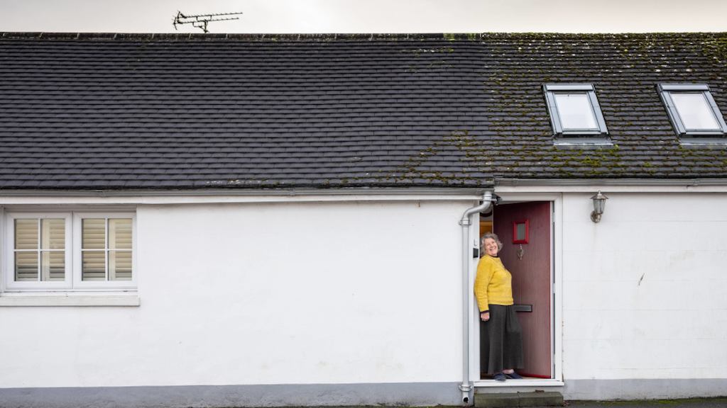 woman stands in front of bungalow