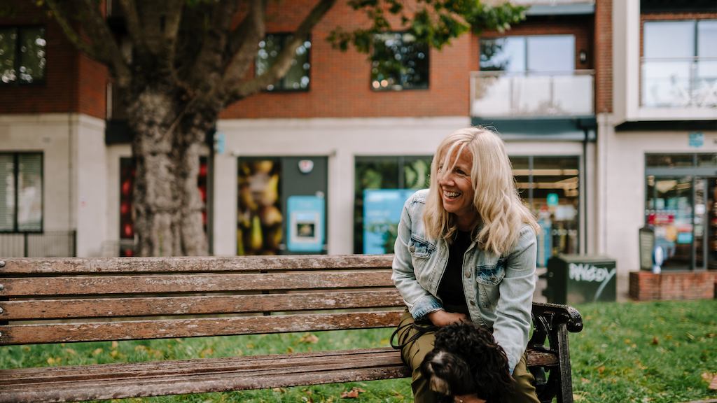 older woman sitting with a dog