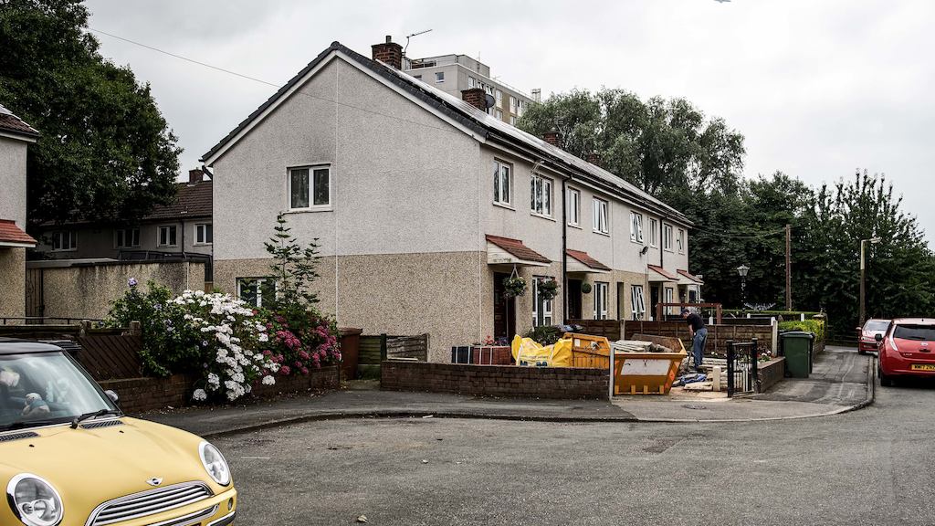 row of houses with cars outside
