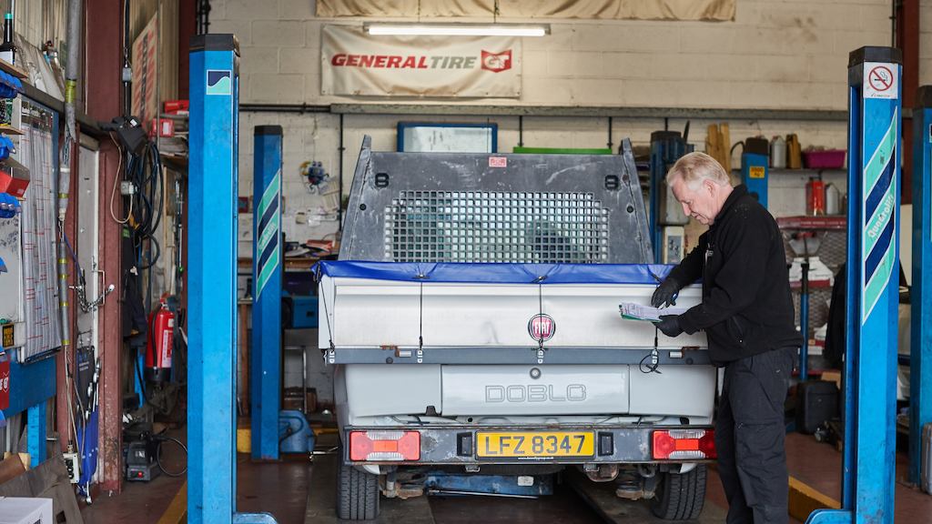 Older man working on car