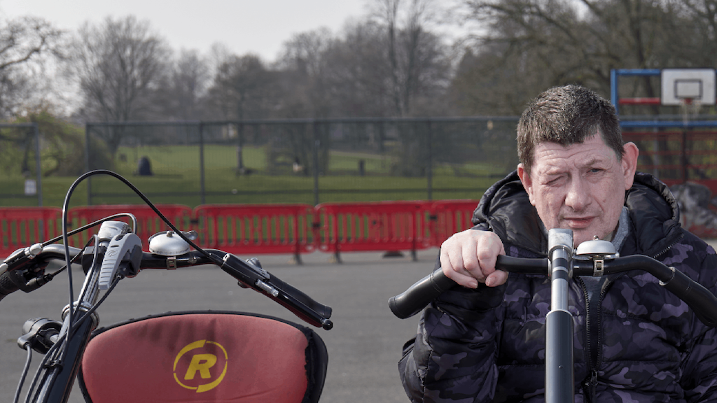 Dave sitting on a side by side bicycle