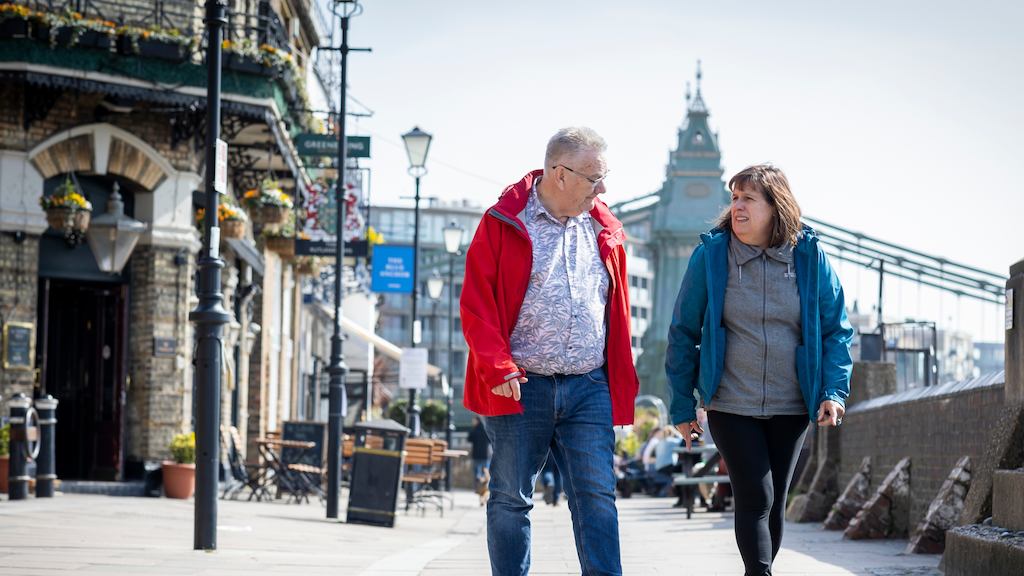 older man and woman walking down the street