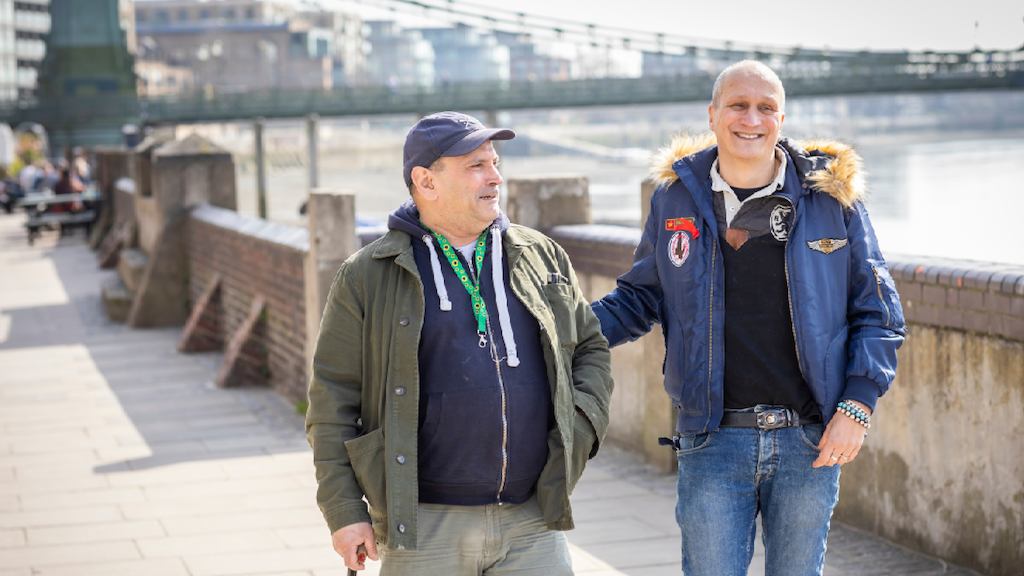 two older men walking and talking