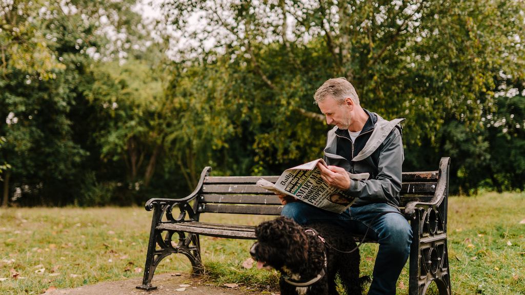 Older man reading a newspaper