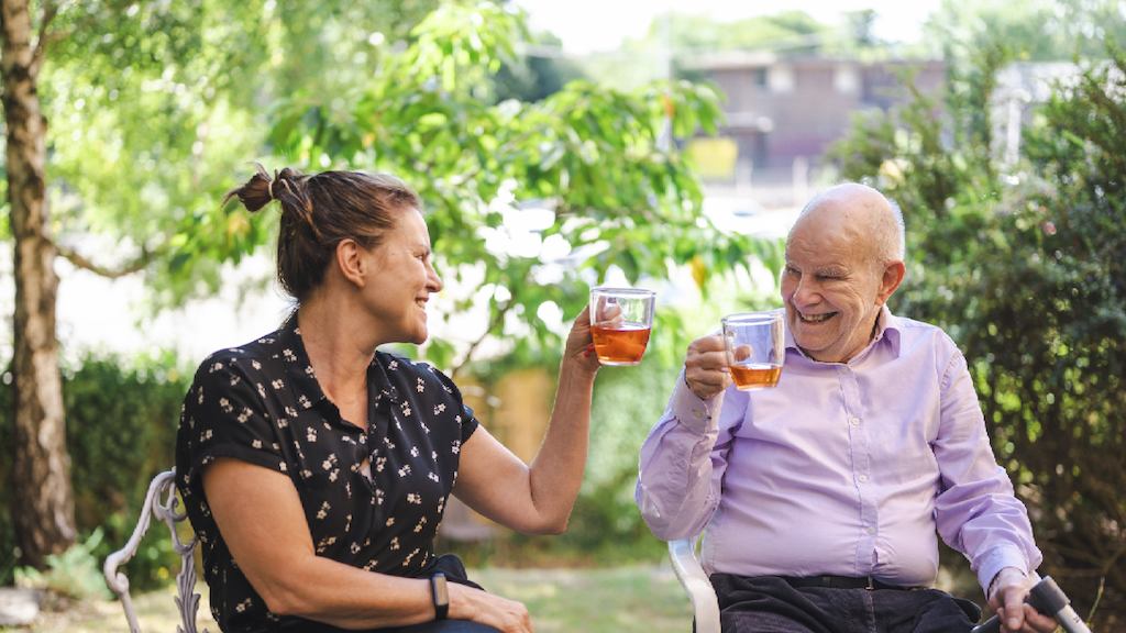Older man and woman drinking tea together