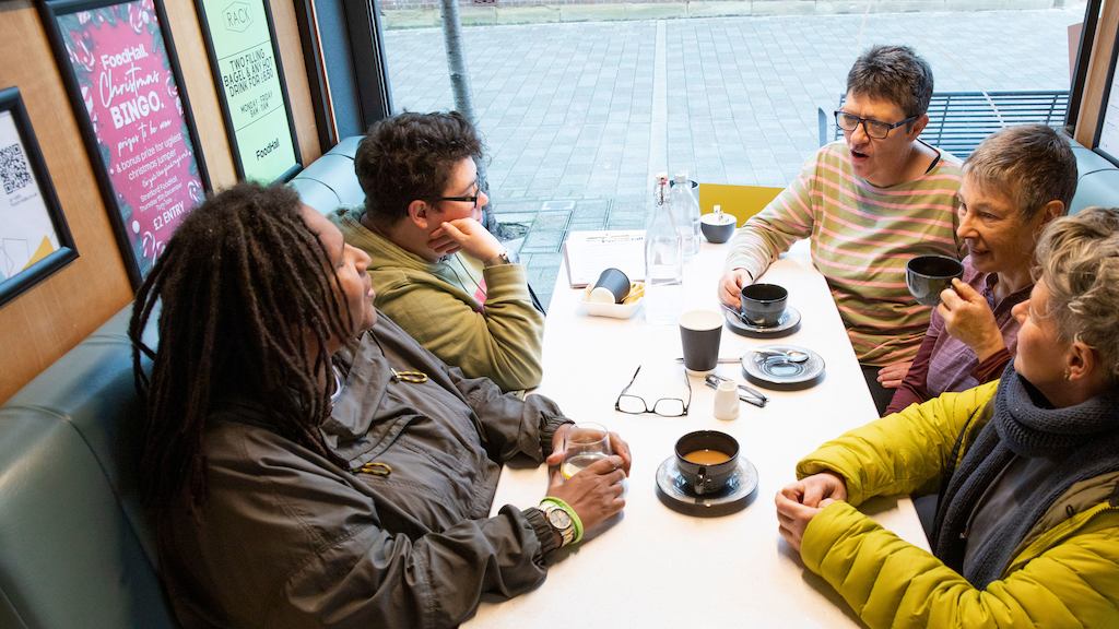 Group of older women sat together and talking