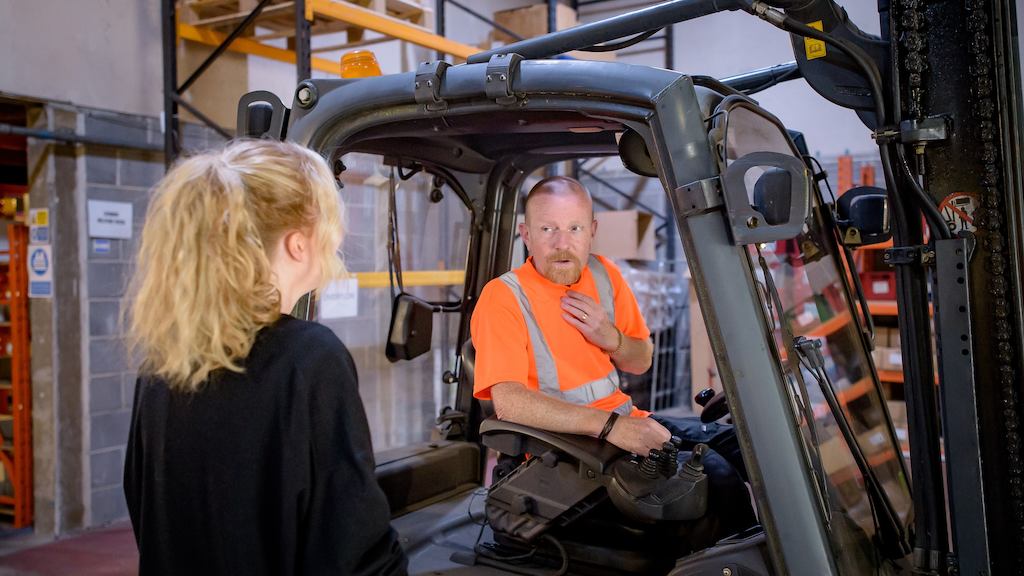 two older workers in a warehouse