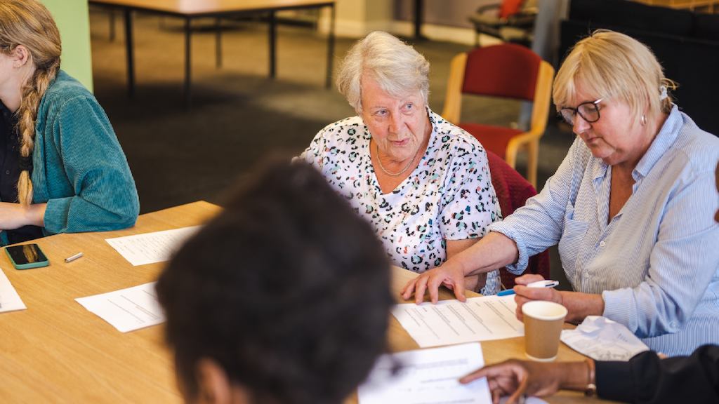 Group of older people sitting together chatting