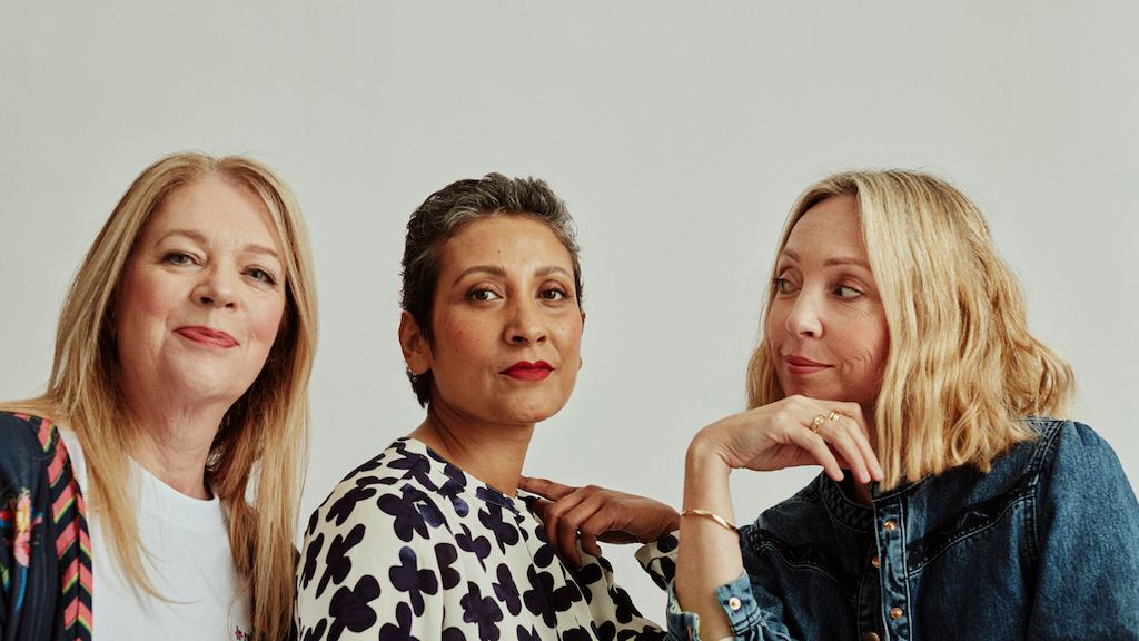 Three older women looking at the camera