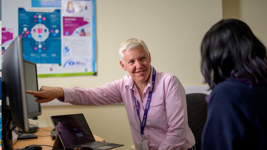 Two older women working from a desk