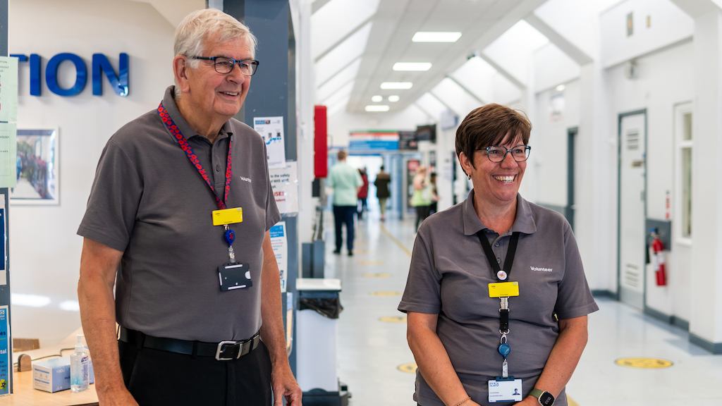 Two older volunteers in a hospital