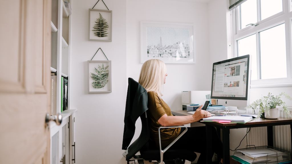Blonde woman working at computer