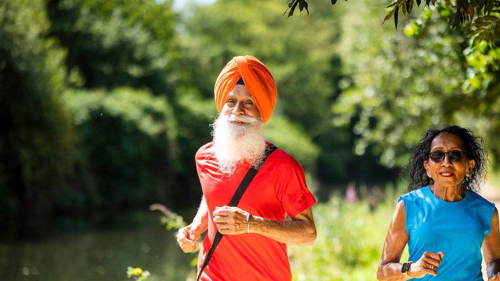 Two older people running