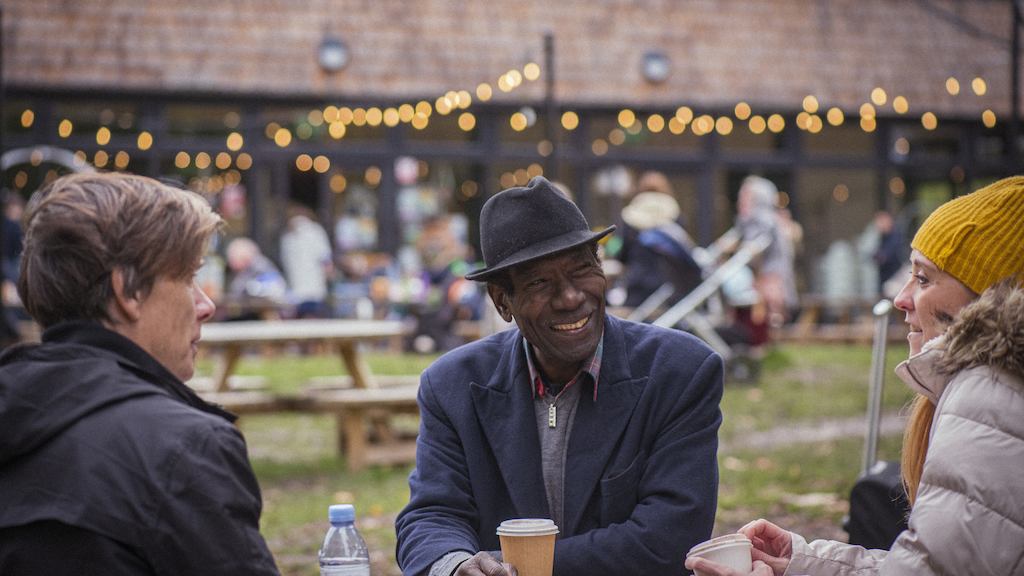 People sitting round the table having coffee and laughing