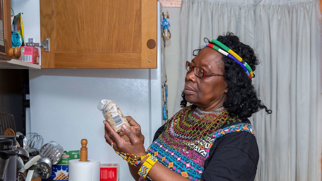 Older woman in kitchen looking at ingredients