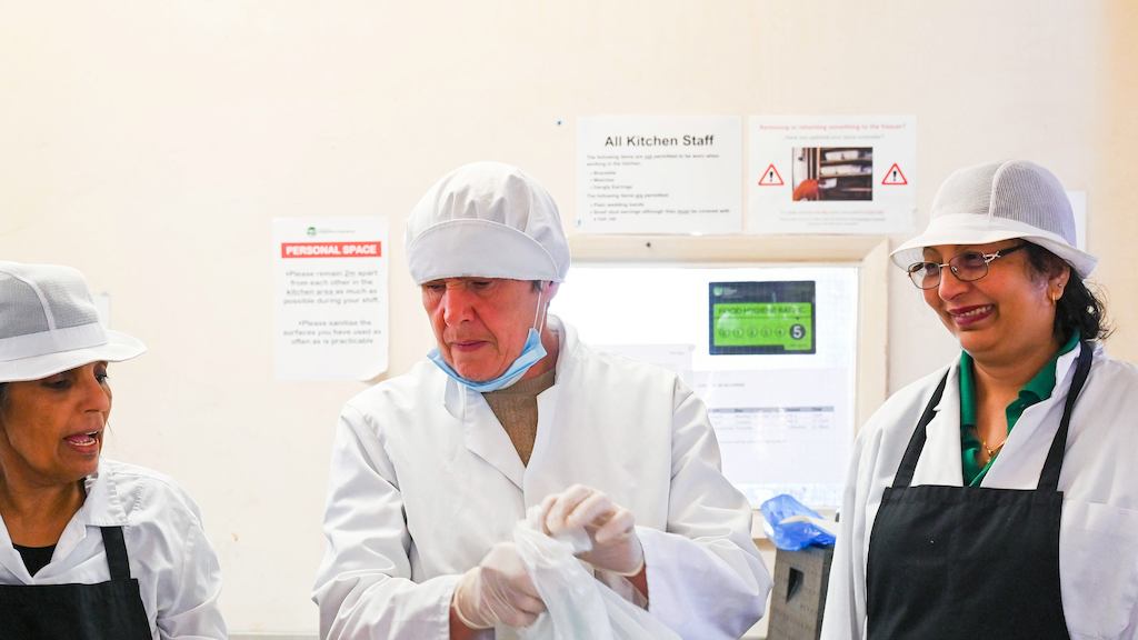 Older people working in a kitchen