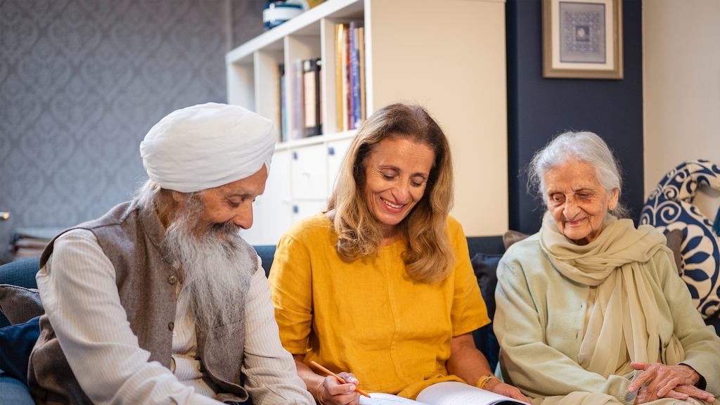 Three older people on a sofa