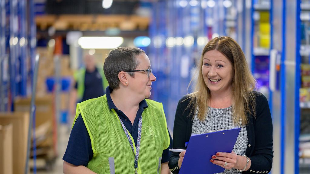 Two older woman at work with a clipboard