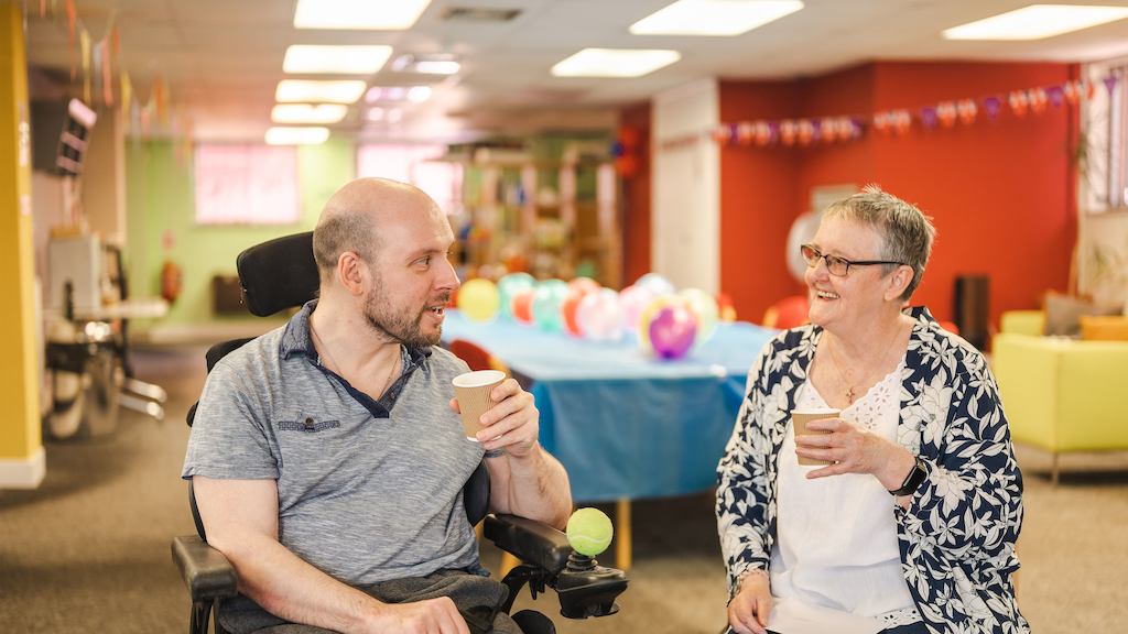 Older woman caring for an older man