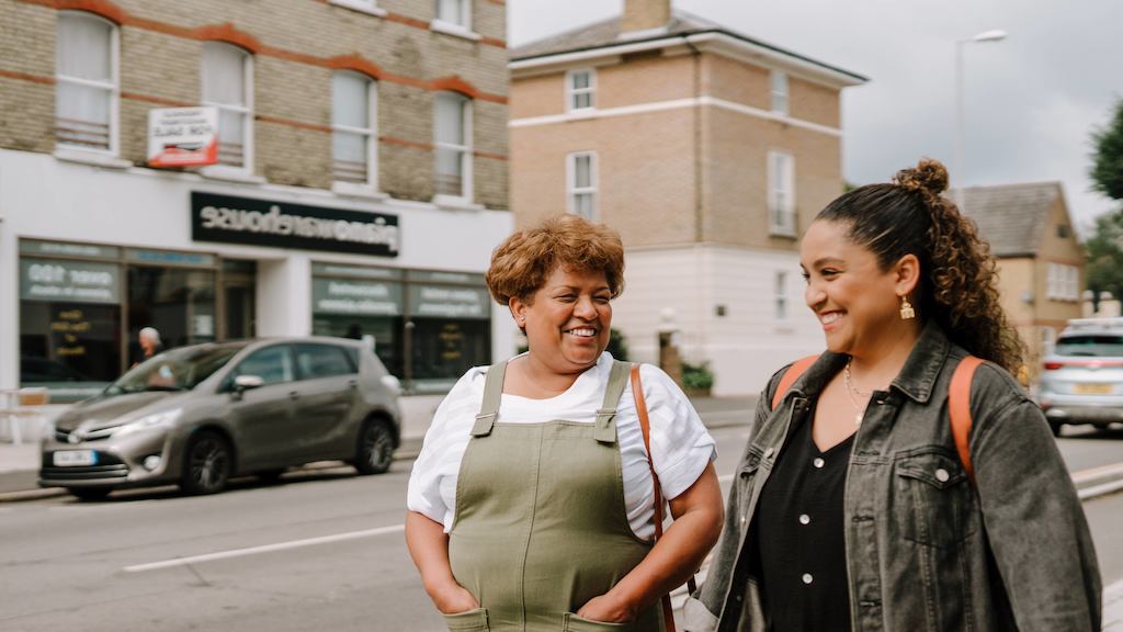 Two women walking down the street together