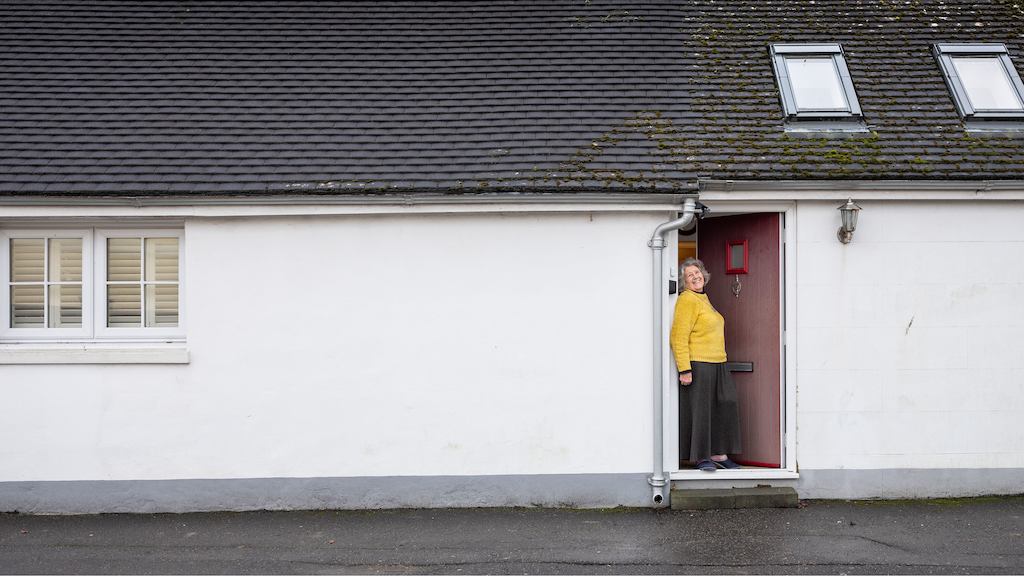 Older woman in house doorway