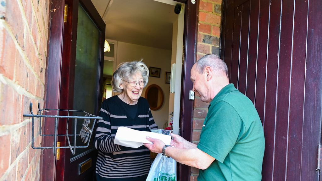 Older-man-delivering-shopping-to-an-older-woman