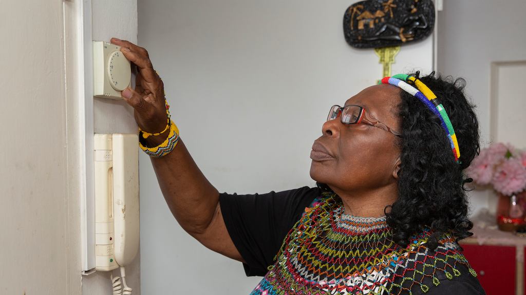 Older-woman-using-thermostat