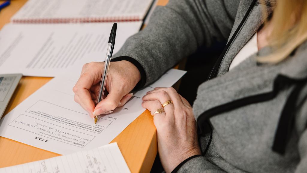 Person-writing-on-paper