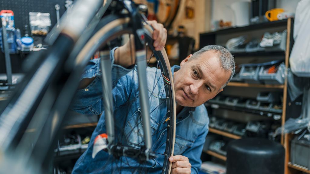 Older-man-working-with-a-bike