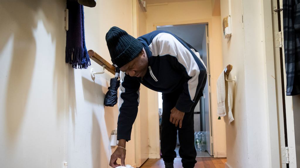 Older-man-adjusting-dehumidifier