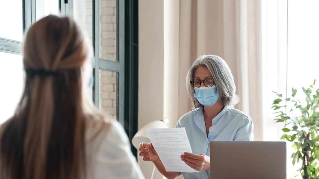 Older-woman-in-a-mask-at-a-job-interview