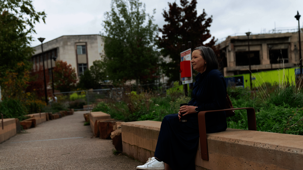 An older woman sitting on a bench