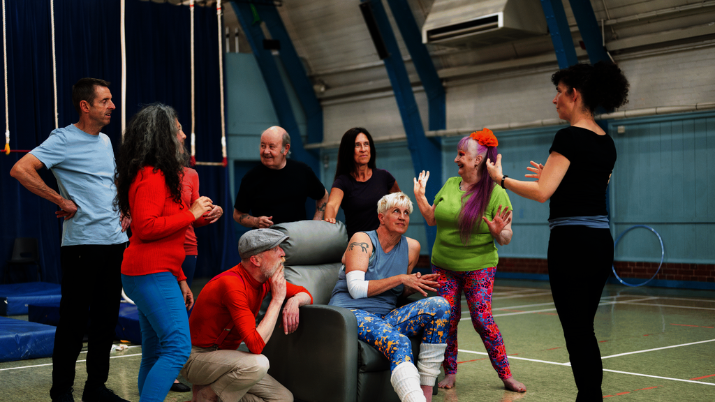 A group of people chat inside a circus