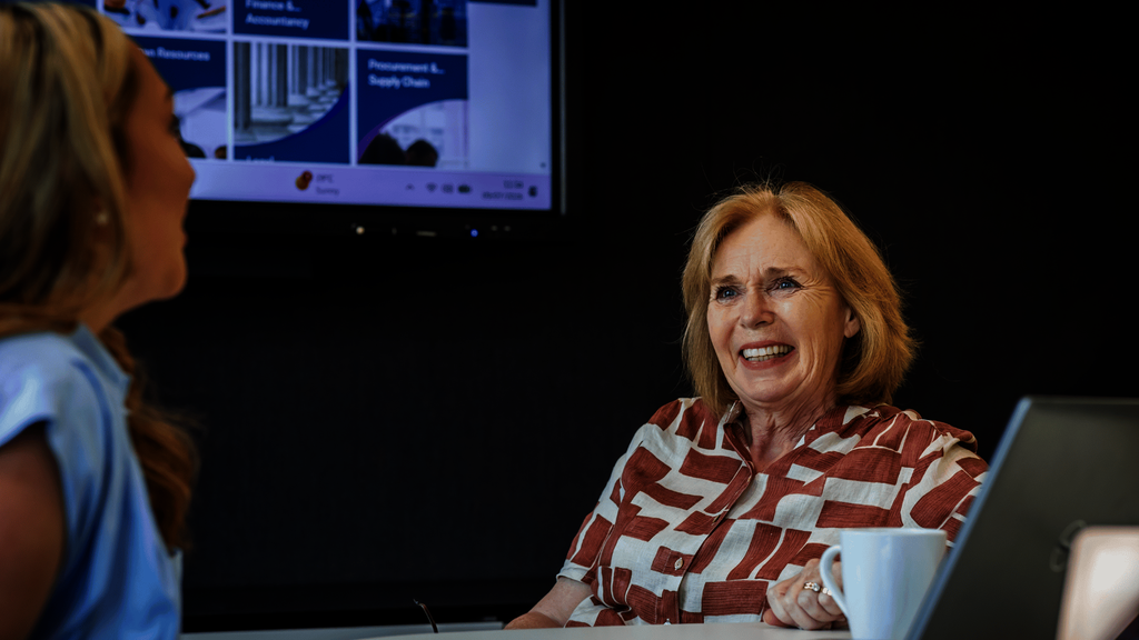 An older woman at work in front of a laptop