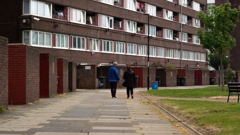 Man and woman walking on an estate.
