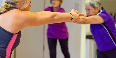 Two women stretching arms