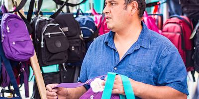 older worker selling bags