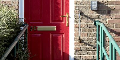 Red front door with grab rails